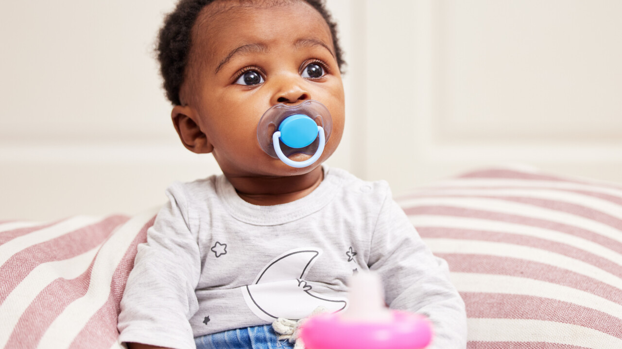 infant with pacifier.